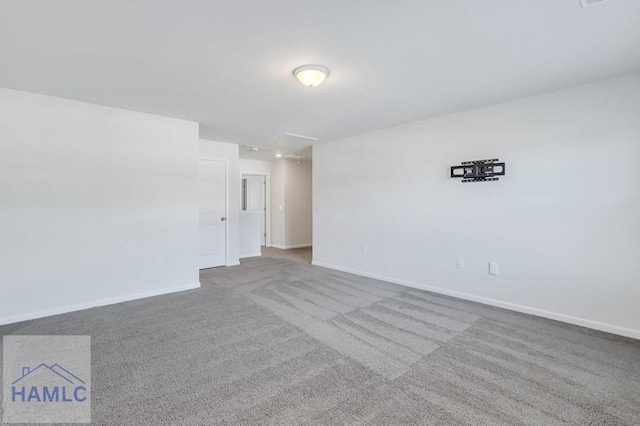 carpeted empty room with baseboards