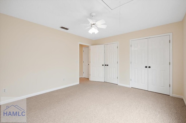 301 Marsh View Dr, Richmond Hill, GA 31324 - unfurnished bedroom featuring multiple closets, carpet floors, attic access, and a ceiling fan