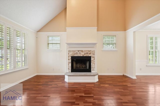 301 Marsh View Dr, Richmond Hill, GA 31324 - unfurnished living room featuring high vaulted ceiling, wood finished floors, and a stone fireplace