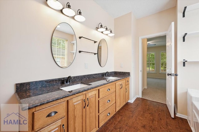 301 Marsh View Dr, Richmond Hill, GA 31324 - full bath featuring wood finished floors, double vanity, and a tub to relax in
