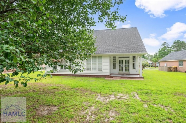 301 Marsh View Dr, Richmond Hill, GA 31324 - back of property featuring french doors, a yard, and a shingled roof