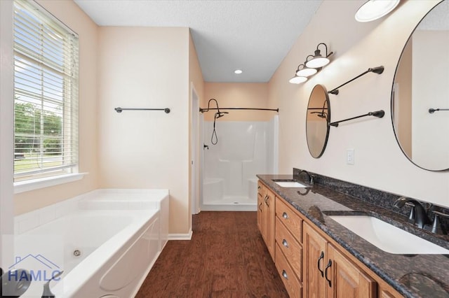 301 Marsh View Dr, Richmond Hill, GA 31324 - full bath featuring a whirlpool tub, walk in shower, double vanity, a textured ceiling, and wood finished floors