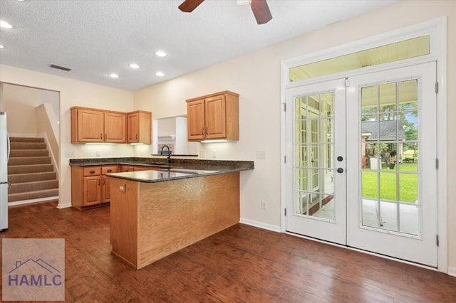 301 Marsh View Dr, Richmond Hill, GA 31324 - kitchen with french doors, dark countertops, recessed lighting, a peninsula, and dark wood-type flooring
