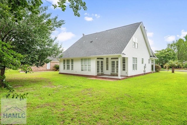 301 Marsh View Dr, Richmond Hill, GA 31324 - rear view of house with french doors, a yard, and a shingled roof
