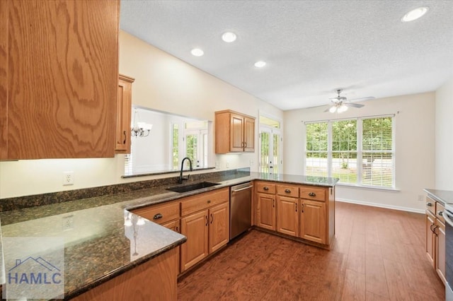 301 Marsh View Dr, Richmond Hill, GA 31324 - kitchen featuring dishwasher, a peninsula, dark wood-style floors, a textured ceiling, and a ceiling fan