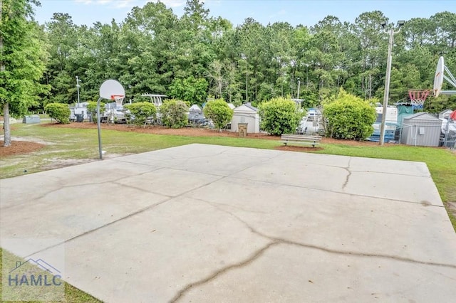 301 Marsh View Dr, Richmond Hill, GA 31324 - view of patio with a storage shed, basketball court, and view of scattered trees