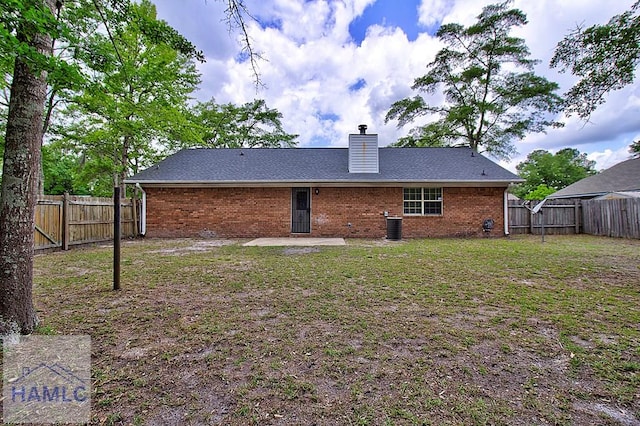 back of property with cooling unit, a lawn, and a patio