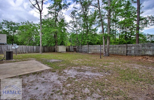 view of yard featuring a storage shed and a patio