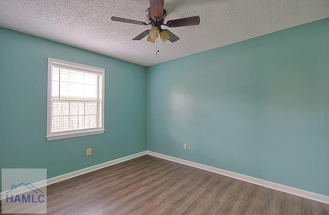 spare room featuring ceiling fan, wood-type flooring, and a textured ceiling