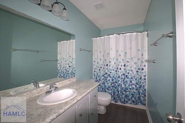 bathroom with vanity, toilet, curtained shower, and hardwood / wood-style floors