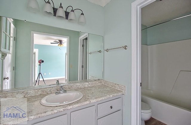 full bathroom with vanity, ceiling fan, washtub / shower combination, and toilet