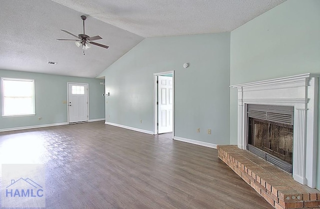 unfurnished living room with high vaulted ceiling, a fireplace, ceiling fan, dark wood-type flooring, and a textured ceiling