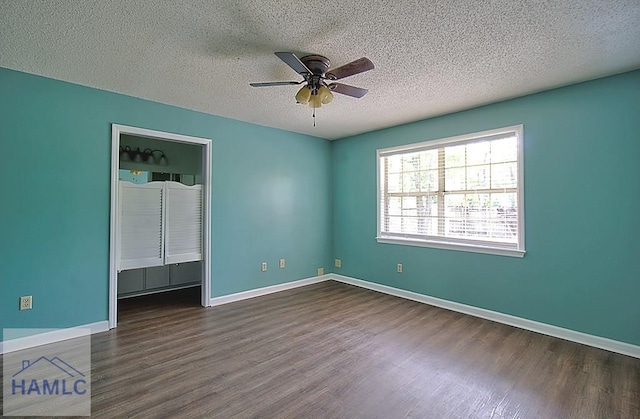 interior space with ceiling fan, dark hardwood / wood-style floors, and a textured ceiling