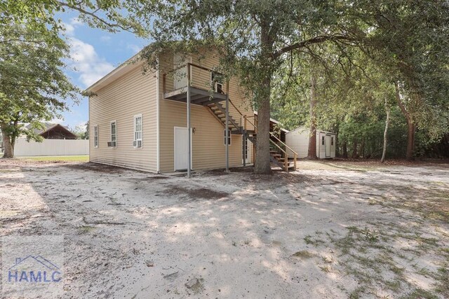 661 E Plum St, Jesup, GA 31546 - back of house with stairs and a shed