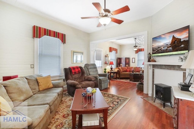 661 E Plum St, Jesup, GA 31546 - living room with ceiling fan, a wood stove, and wood finished floors