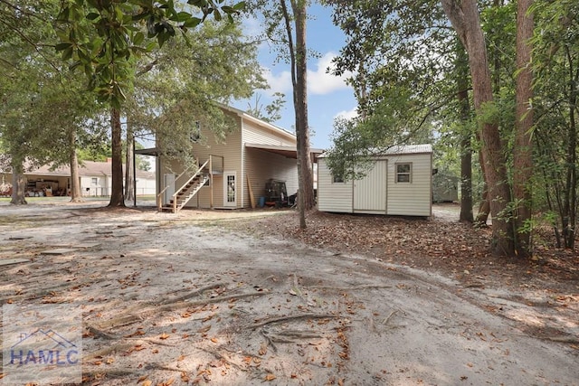 661 E Plum St, Jesup, GA 31546 - back of property with stairs and a shed