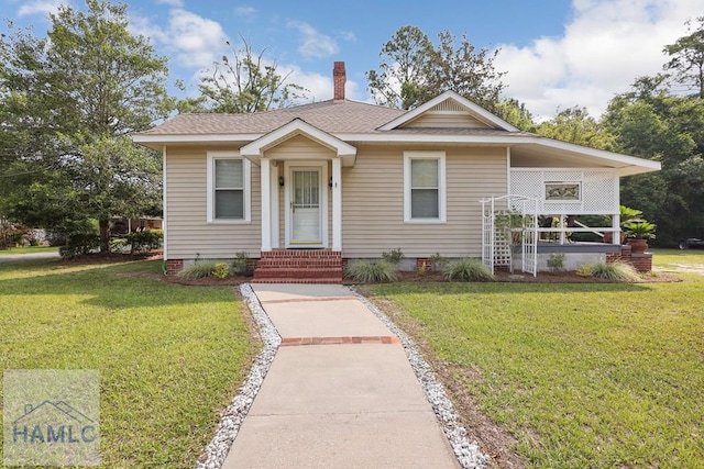 661 E Plum St, Jesup, GA 31546 - bungalow featuring a front lawn, a chimney, entry steps, and roof with shingles