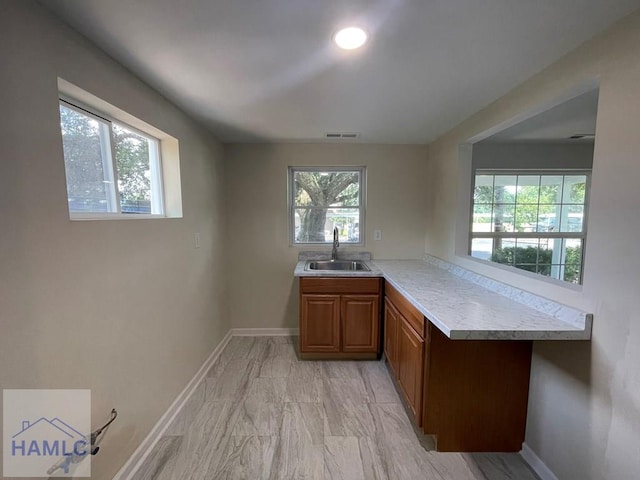 interior space featuring kitchen peninsula and sink