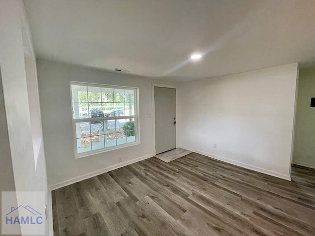 unfurnished room with hardwood / wood-style floors