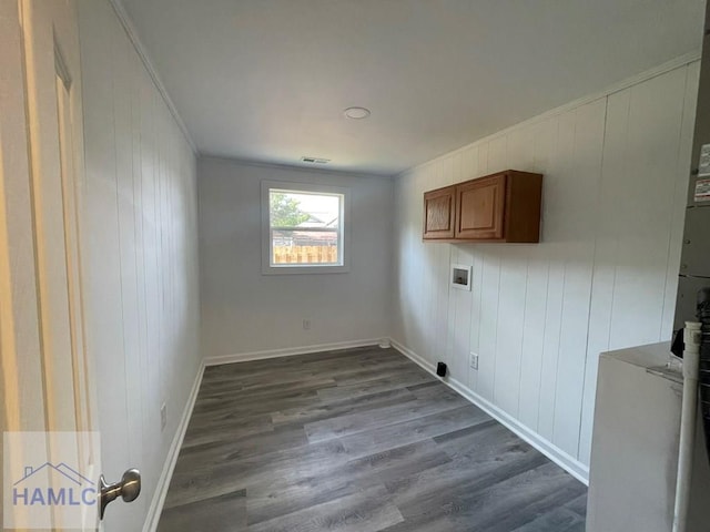 laundry room featuring washer hookup, cabinets, crown molding, wooden walls, and hardwood / wood-style flooring