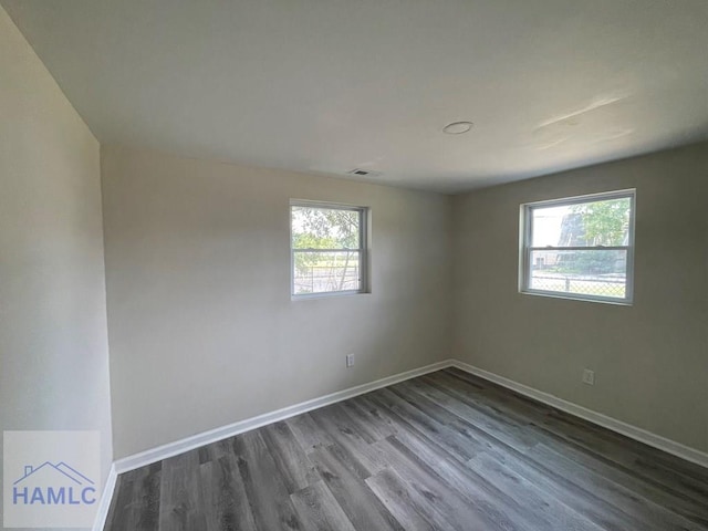 unfurnished room with hardwood / wood-style floors