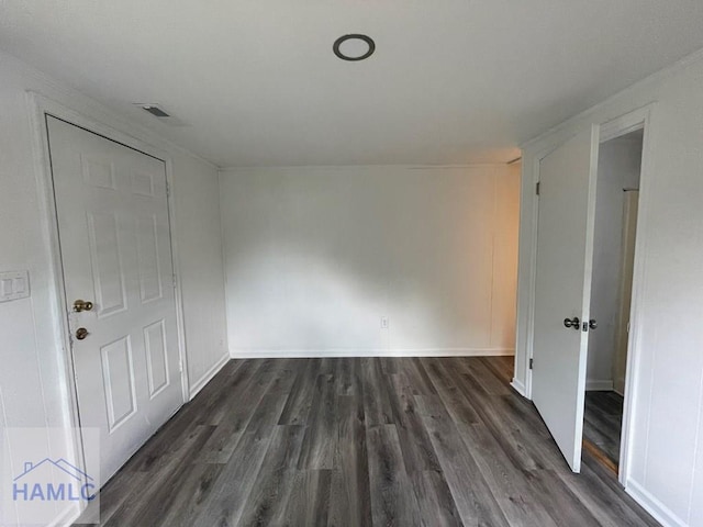 unfurnished room featuring dark wood-type flooring