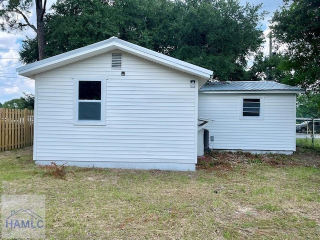 view of property exterior with a lawn