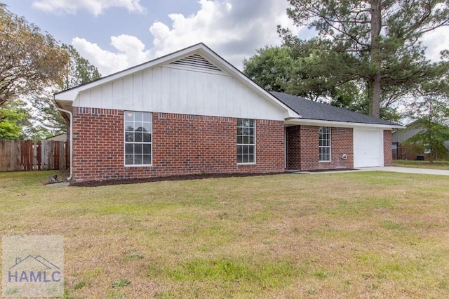 52 Pheasant Way, Hinesville, GA 31313 - view of home's exterior featuring a garage, fence, a lawn, concrete driveway, and brick siding