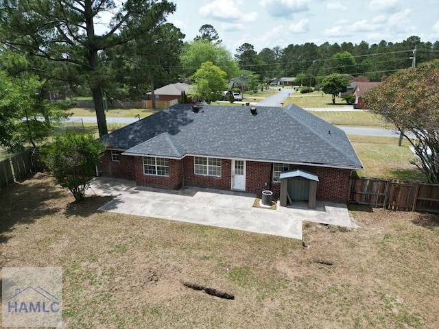 52 Pheasant Way, Hinesville, GA 31313 - rear view of property featuring a shingled roof, a patio, and a yard