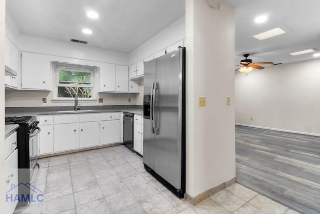 kitchen with range hood, range with gas cooktop, visible vents, a sink, and stainless steel fridge with ice dispenser