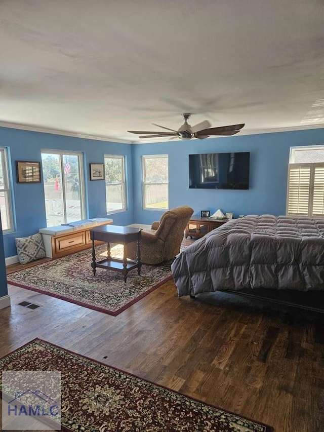 bedroom featuring ceiling fan, crown molding, and hardwood / wood-style flooring