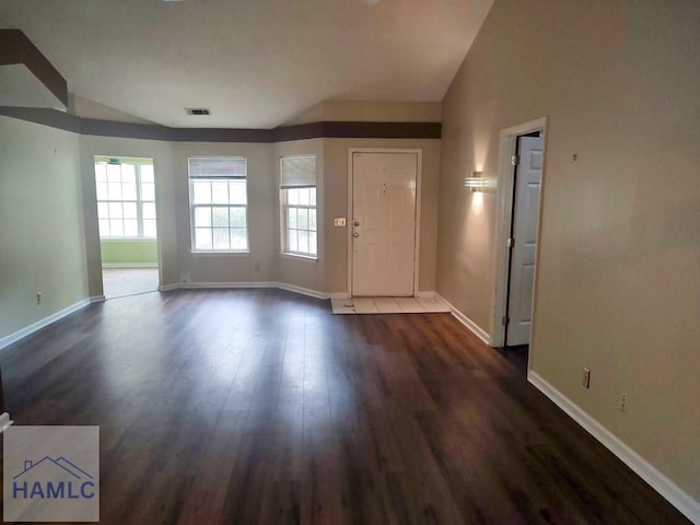 foyer featuring dark wood-type flooring and lofted ceiling