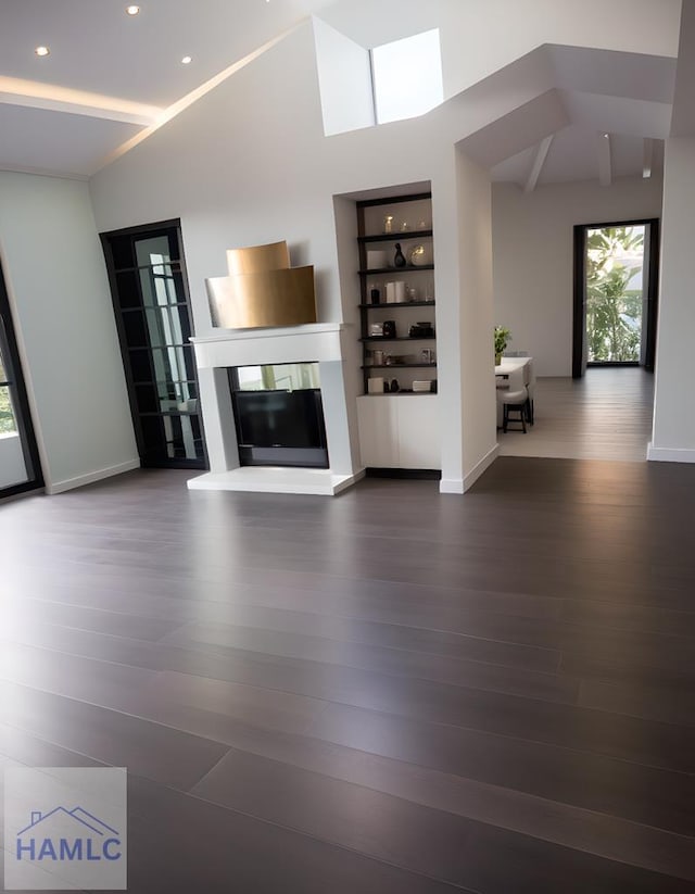 unfurnished living room with dark hardwood / wood-style flooring