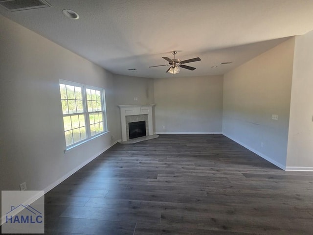 132 Turpentine Trl, Hinesville, GA 31313 - unfurnished living room with dark wood-style flooring, ceiling fan, baseboards, a fireplace with raised hearth, and recessed lighting