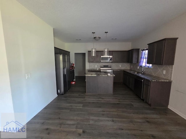 132 Turpentine Trl, Hinesville, GA 31313 - kitchen with stainless steel appliances, dark wood-style flooring, a center island, tasteful backsplash, and a sink