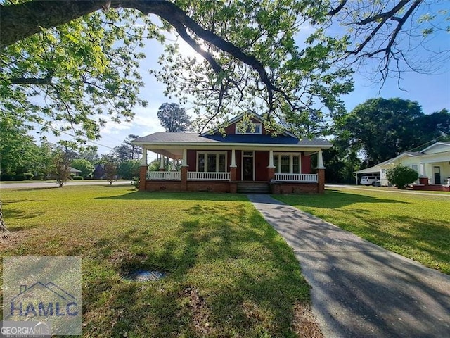 11 Marguerite St, Claxton, GA 30417 - view of front of house with covered porch and a front yard