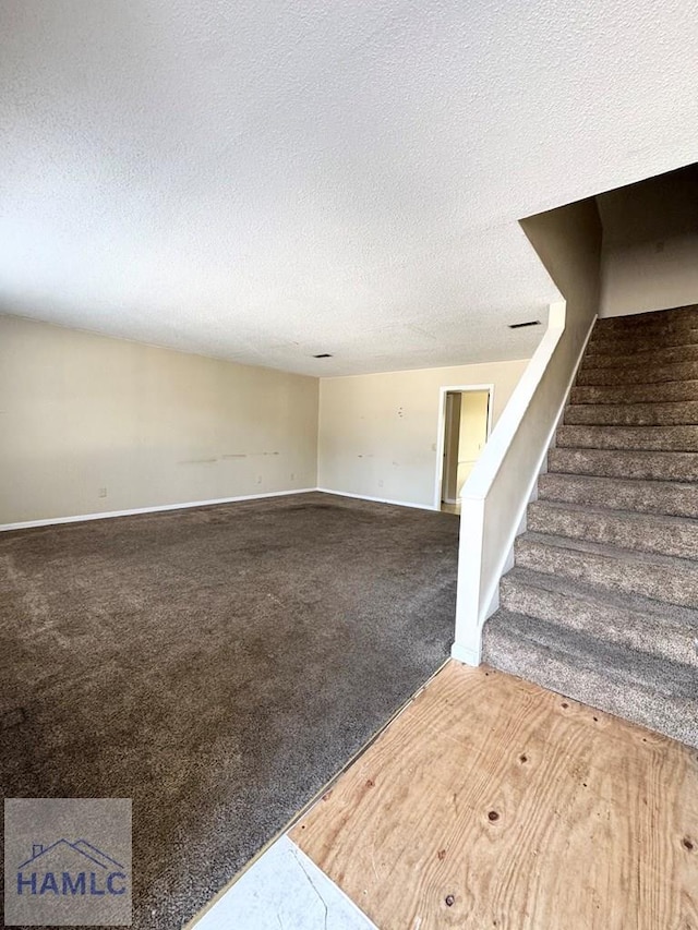 interior space featuring carpet and a textured ceiling