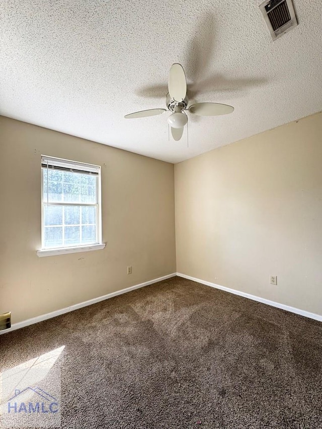 carpeted empty room with ceiling fan and a textured ceiling