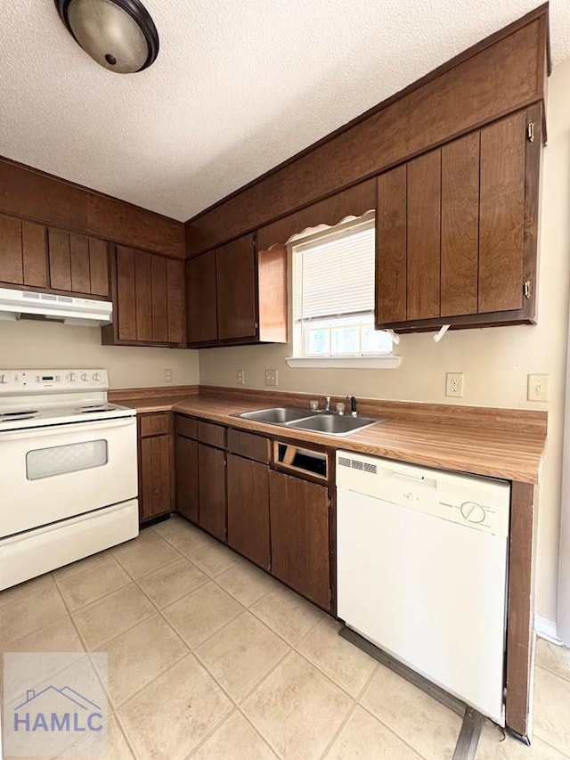 kitchen featuring a textured ceiling, dark brown cabinets, sink, and white appliances