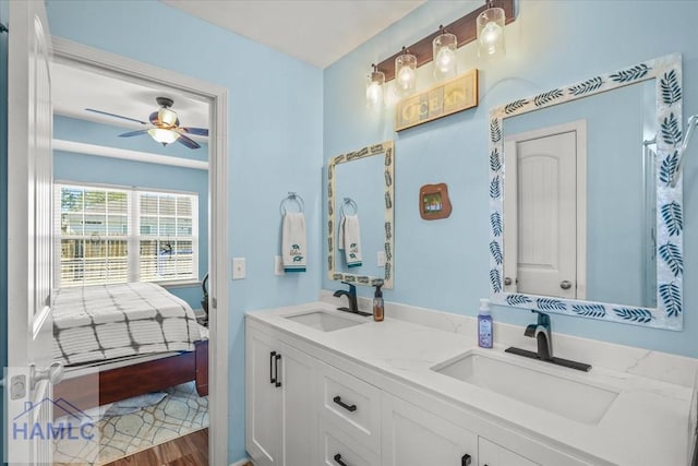 full bathroom with double vanity, a sink, ensuite bath, and wood finished floors