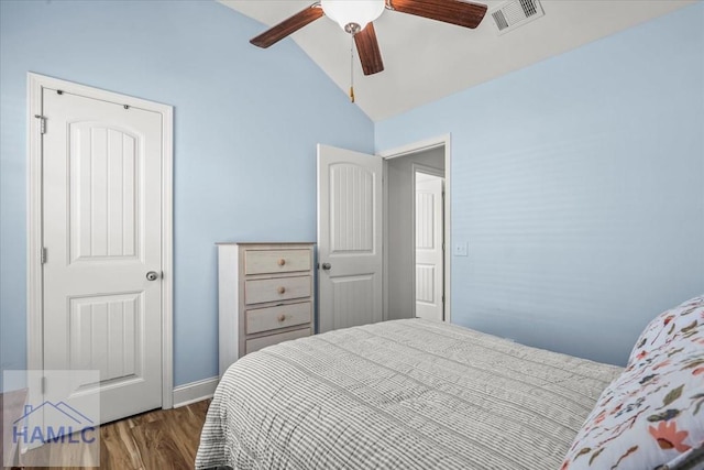 bedroom featuring lofted ceiling, visible vents, a ceiling fan, and wood finished floors