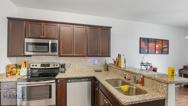 25 Walker Ct, Richmond Hill, GA 31324 - kitchen featuring tasteful backsplash, a peninsula, a sink, and stainless steel appliances