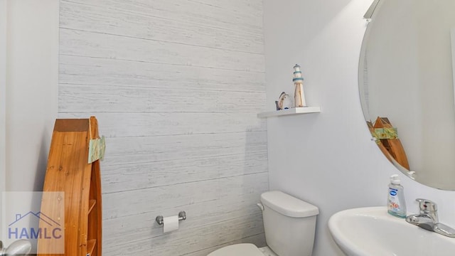 25 Walker Ct, Richmond Hill, GA 31324 - half bath featuring a sink, toilet, and wood walls