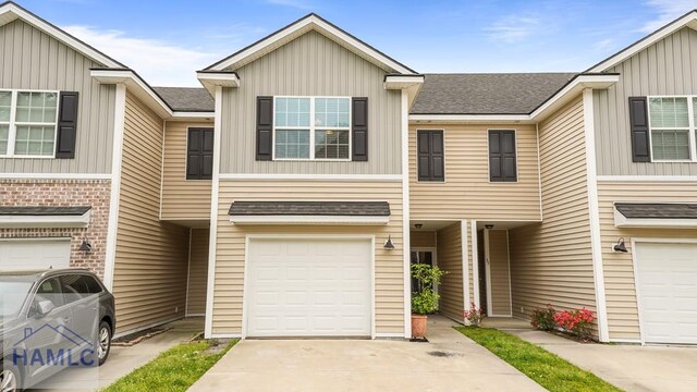25 Walker Ct, Richmond Hill, GA 31324 - townhome / multi-family property with an attached garage, board and batten siding, concrete driveway, and roof with shingles