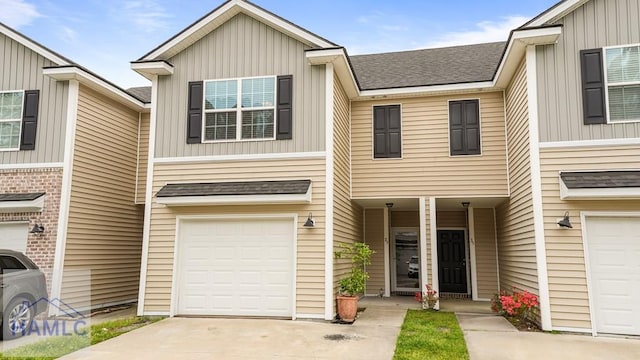 25 Walker Ct, Richmond Hill, GA 31324 - view of property featuring roof with shingles, a garage, board and batten siding, and concrete driveway