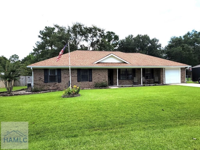 ranch-style home with a garage, a front lawn, and cooling unit