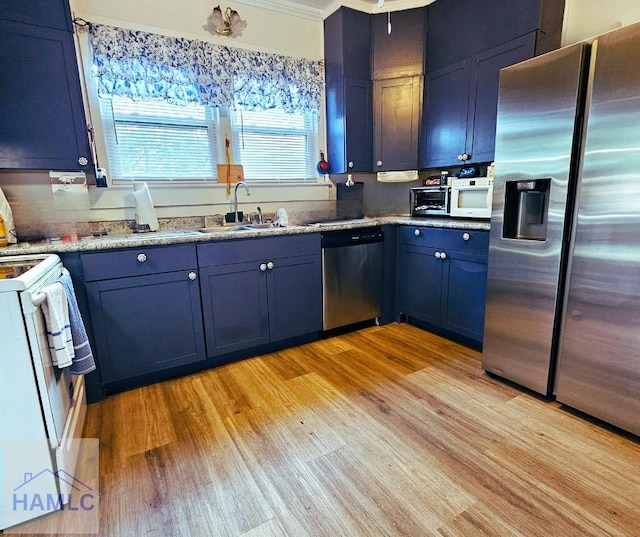 kitchen with sink, light hardwood / wood-style flooring, blue cabinetry, stainless steel appliances, and light stone countertops