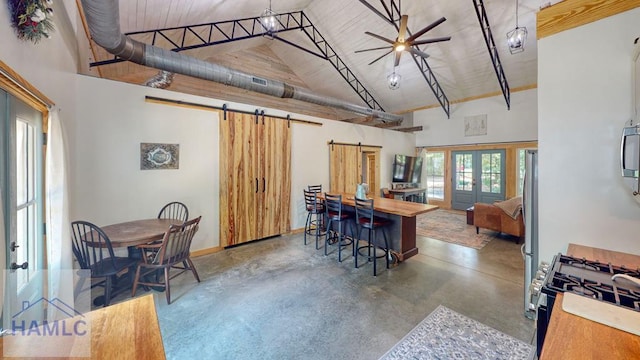 26 Cason Rd, Pembroke, GA 31321 - kitchen featuring a barn door, concrete floors, high vaulted ceiling, appliances with stainless steel finishes, and french doors