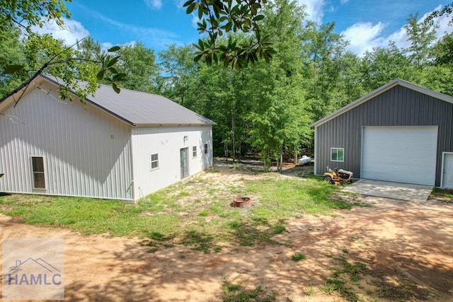 26 Cason Rd, Pembroke, GA 31321 - view of yard featuring a detached garage and an outbuilding