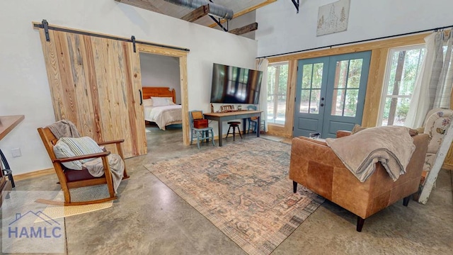 26 Cason Rd, Pembroke, GA 31321 - living room with french doors, finished concrete flooring, a barn door, and a high ceiling